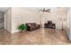 Open-concept living room with tile flooring, ceiling fan, and neutral decor. Perfect for entertaining at 5016 S Curie Way, Mesa, AZ 85212
