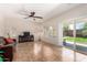 Comfortable living room with tile flooring, ceiling fan, sliding glass door, and entertainment center at 5016 S Curie Way, Mesa, AZ 85212