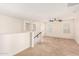 Spacious loft area with neutral carpeting, a ceiling fan, and natural light at 5016 S Curie Way, Mesa, AZ 85212