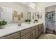 Bright bathroom featuring double sinks, modern fixtures, and clean design at 5437 W Red Bird Rd, Phoenix, AZ 85083