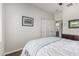 Cozy bedroom featuring a comfortable bed, closet space, and serene decor for a peaceful retreat at 5437 W Red Bird Rd, Phoenix, AZ 85083