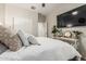 Bright bedroom with a large TV, modern decor, and ample natural light at 5437 W Red Bird Rd, Phoenix, AZ 85083