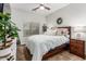 Cozy bedroom with a large bed, soft lighting, and decorative plants at 5437 W Red Bird Rd, Phoenix, AZ 85083