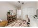 Bedroom with a desk, shelving unit, and ample storage space at 5437 W Red Bird Rd, Phoenix, AZ 85083