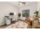 Multipurpose room with desk, seating, and a large sunny window at 5437 W Red Bird Rd, Phoenix, AZ 85083