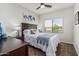 Bright bedroom features a ceiling fan and large window with neighborhood views at 5437 W Red Bird Rd, Phoenix, AZ 85083