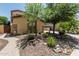 Landscaped front yard featuring desert plants, trees, and a paved walkway leading to the entrance of the home at 5437 W Red Bird Rd, Phoenix, AZ 85083