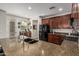 The kitchen includes a large island with a sink, granite countertops, and dark wood cabinets at 5437 W Red Bird Rd, Phoenix, AZ 85083