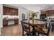 The kitchen offers dark wood cabinets, granite countertops, and a large island with a breakfast bar at 5437 W Red Bird Rd, Phoenix, AZ 85083