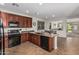 The kitchen features dark wood cabinets, granite countertops, and black appliances at 5437 W Red Bird Rd, Phoenix, AZ 85083