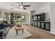 Living room with entertainment center and a sliding glass door leading to the backyard at 5437 W Red Bird Rd, Phoenix, AZ 85083