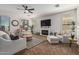 Spacious living room features a ceiling fan, fireplace, and neutral color palette at 5437 W Red Bird Rd, Phoenix, AZ 85083