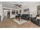 Cozy living room with leather furniture, ceiling fan, and open layout at 5437 W Red Bird Rd, Phoenix, AZ 85083