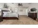 The main bedroom has carpet, neutral walls, and a large bed at 5437 W Red Bird Rd, Phoenix, AZ 85083