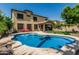 Inviting backyard pool with a curved design, surrounded by a spacious patio, perfect for enjoying sunny days at 5437 W Red Bird Rd, Phoenix, AZ 85083