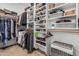 This is a large walk-in closet with built-in shelving and hanging rods at 5437 W Red Bird Rd, Phoenix, AZ 85083