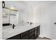 Updated bathroom featuring a double vanity with dark cabinets, a large mirror, and modern fixtures at 609 E Mesquite Cir # D132, Tempe, AZ 85288