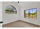 Bedroom featuring large windows with views and modern ceiling fan at 609 E Mesquite Cir # D132, Tempe, AZ 85288