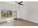 Bedroom with neutral walls and wood look flooring, large window, and closet at 609 E Mesquite Cir # D132, Tempe, AZ 85288