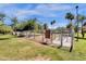 Fenced dog park with lush green grass and shade trees, providing a safe and enjoyable space for pets to play at 609 E Mesquite Cir # D132, Tempe, AZ 85288