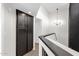 Hallway with modern chandelier, dark wood accents, and a large built-in storage cabinet at 609 E Mesquite Cir # D132, Tempe, AZ 85288