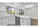 Bright kitchen with white cabinets, stainless steel dishwasher, and sleek countertops at 609 E Mesquite Cir # D132, Tempe, AZ 85288