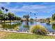 Scenic pond in a park setting, surrounded by lush greenery, palm trees and grassy banks at 609 E Mesquite Cir # D132, Tempe, AZ 85288