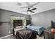Bedroom with gray walls, ceiling fan, wood-look floors, and two twin beds with decorative headboards at 6605 W Altadena Ave, Glendale, AZ 85304