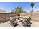 Relaxing outdoor area featuring a cozy fire pit with built-in seating and stylish striped chairs at 6605 W Altadena Ave, Glendale, AZ 85304