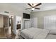 Main bedroom features an en suite bathroom, a ceiling fan, and an entertainment center at 6605 W Altadena Ave, Glendale, AZ 85304