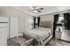 Main bedroom boasts a tufted headboard, wood-look floors, ceiling fan, and dark window treatments at 6605 W Altadena Ave, Glendale, AZ 85304