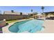 Backyard pool and spa features a gazebo-covered outdoor kitchen, patio dining, and green space at 6605 W Altadena Ave, Glendale, AZ 85304