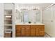 Bright bathroom features a double vanity, linen closet and a glass enclosed walk-in shower at 6719 W Sack Dr, Glendale, AZ 85308