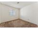 Bedroom featuring neutral colored carpet, a window, and white walls at 6719 W Sack Dr, Glendale, AZ 85308