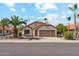 Charming single-story home featuring a two-car garage and a well-maintained front yard with mature palm trees at 6719 W Sack Dr, Glendale, AZ 85308