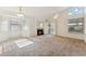 Cozy living room with a fireplace, a ceiling fan, and natural light streaming through the window at 6719 W Sack Dr, Glendale, AZ 85308
