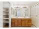 Double vanity main bathroom featuring an enclosed shower and built-in linen shelves at 6719 W Sack Dr, Glendale, AZ 85308
