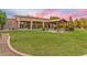 The backyard has a covered seating area and lush green grass perfect for relaxation and outdoor activities at 6861 W Calle Lejos --, Peoria, AZ 85383