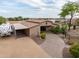 Barn exterior showing horse stalls with a trailer parked, landscaping, and stone driveway at 6861 W Calle Lejos --, Peoria, AZ 85383