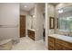 Bathroom with wooden cabinets, dual sinks, and a separate bath and shower area at 6861 W Calle Lejos --, Peoria, AZ 85383