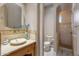 A serene bathroom features a vessel sink, toilet, and a tiled shower area, blending simplicity with refined taste at 6861 W Calle Lejos --, Peoria, AZ 85383