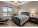 Inviting bedroom with a comfortable bed, side table, lamps, and a view outside the window at 6861 W Calle Lejos --, Peoria, AZ 85383