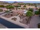 Stunning desert home with a circular driveway, lush landscaping, and mountain views at 6861 W Calle Lejos --, Peoria, AZ 85383