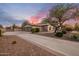 Charming home featuring a large driveway, mature landscaping, and a three-car garage, offering ample parking at 6861 W Calle Lejos --, Peoria, AZ 85383
