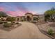 Beautiful front exterior with a circular driveway and desert landscaping at 6861 W Calle Lejos --, Peoria, AZ 85383