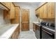 Spacious laundry room equipped with modern washer, dryer, a sink, counter space, and ample storage cabinets at 6861 W Calle Lejos --, Peoria, AZ 85383
