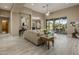 Large living room featuring stylish decor, wood floors, and ample natural light at 6861 W Calle Lejos --, Peoria, AZ 85383