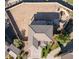 Overhead view of a home showcasing its unique roof design, backyard layout, and surrounding landscaping at 7102 W Pueblo Ave, Phoenix, AZ 85043