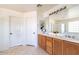 Bright bathroom with a double sink vanity, large mirror, and white cabinets, offering ample space and functionality at 7102 W Pueblo Ave, Phoenix, AZ 85043