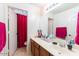 Bathroom features double vanity, sink, mirror, and a door leading to the shower at 7102 W Pueblo Ave, Phoenix, AZ 85043